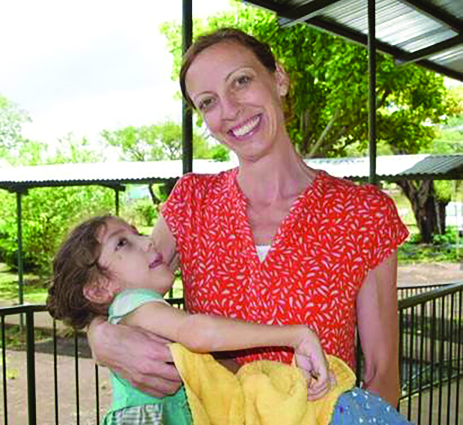A women holds a child in her lap