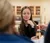 Along with others a young woman looks at dropper in science lab