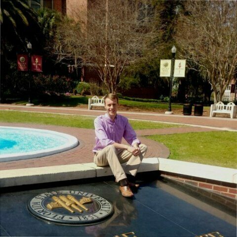 A student sits on Florida State University's campus
