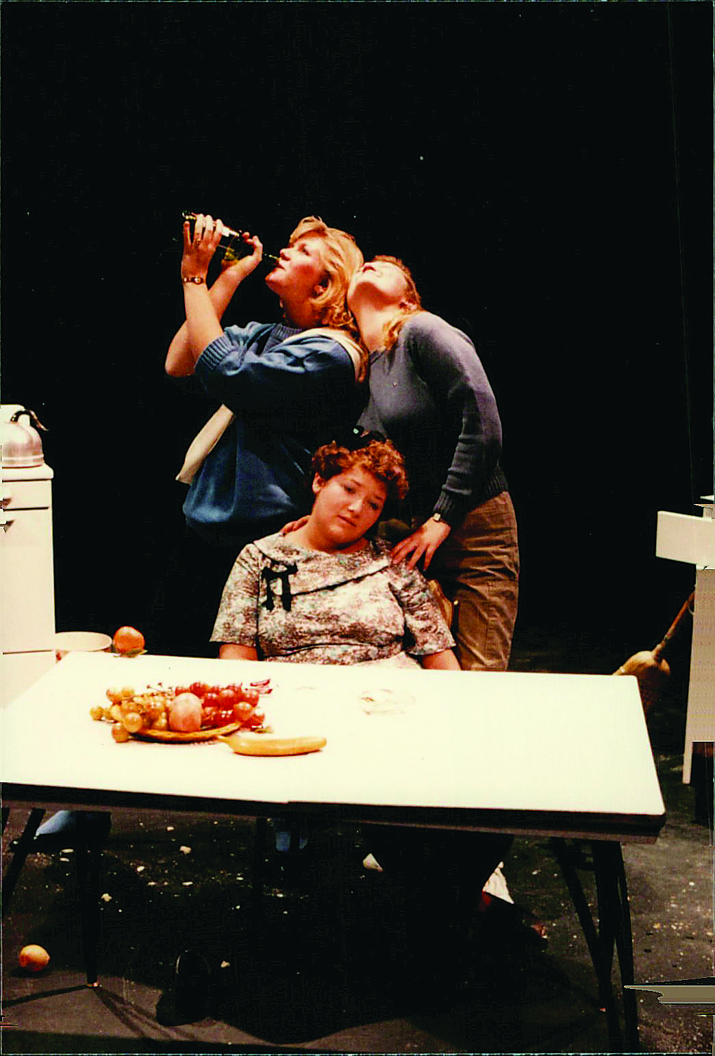 Three student actors pretend to be drunk on stage