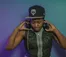 A picture of a woman in a Twins baseball cap putting on headphones
