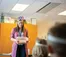 A teacher presents a tub full of shapes to a class