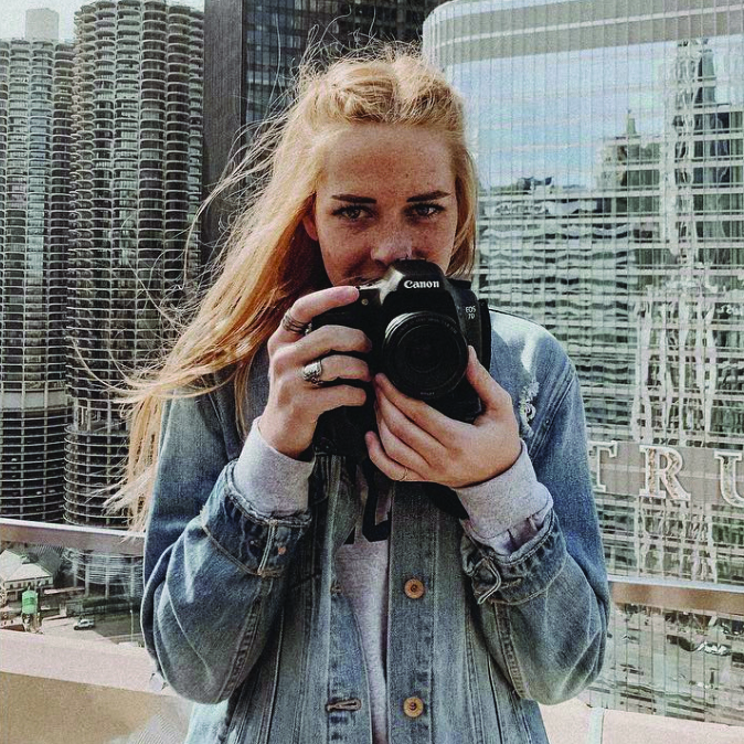 A picture of a student holding a camera