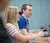 A male student sits at his computer in a classroom and looks up