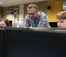 A picture of a professor helping students in a digital media lab