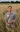 Man standing in field of grain holds onto bunch of it