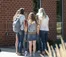 A picture of student standing in a circle outside of the Commons