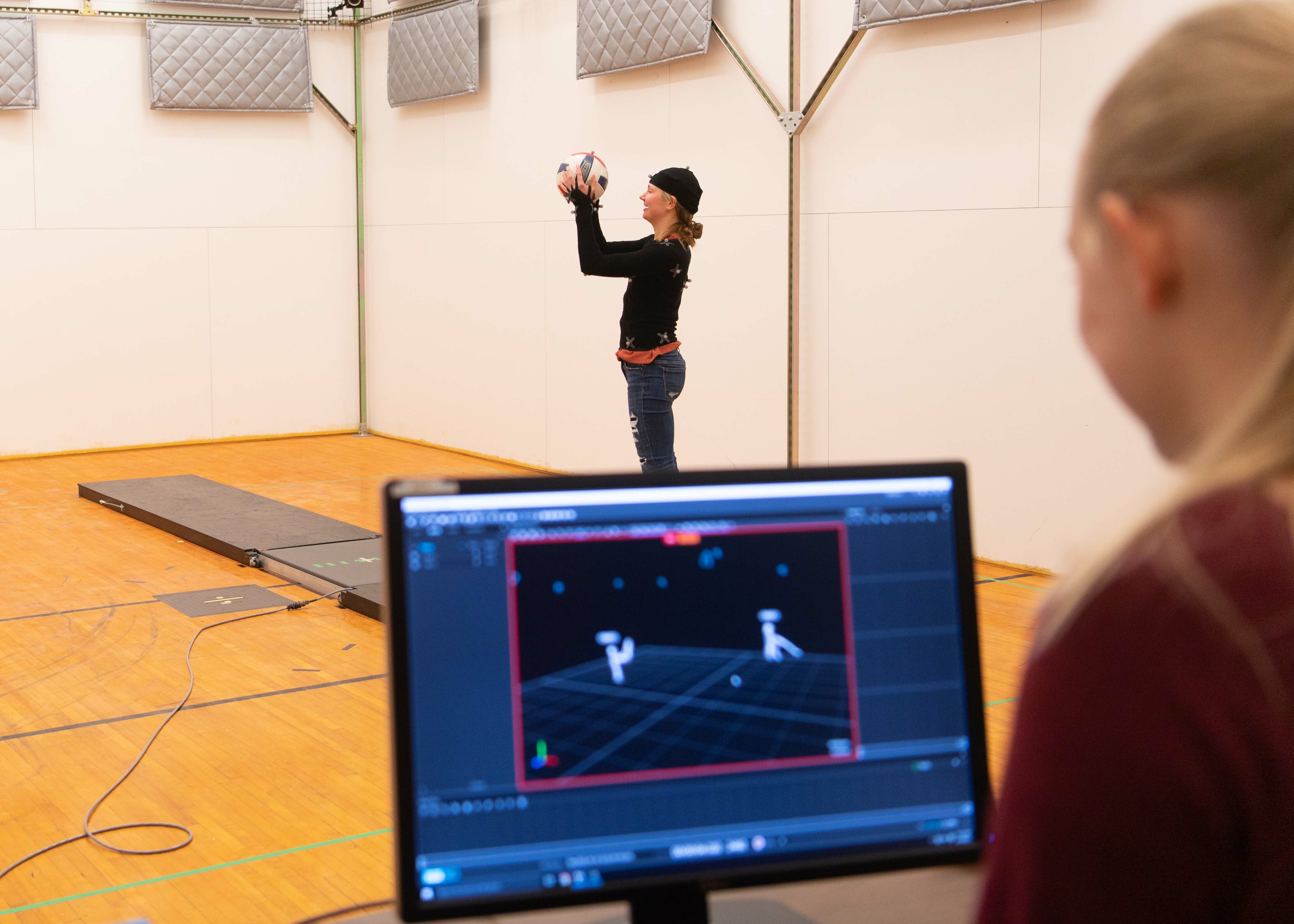 A student in the biomechanics lab does movement that shows up on a computer screen