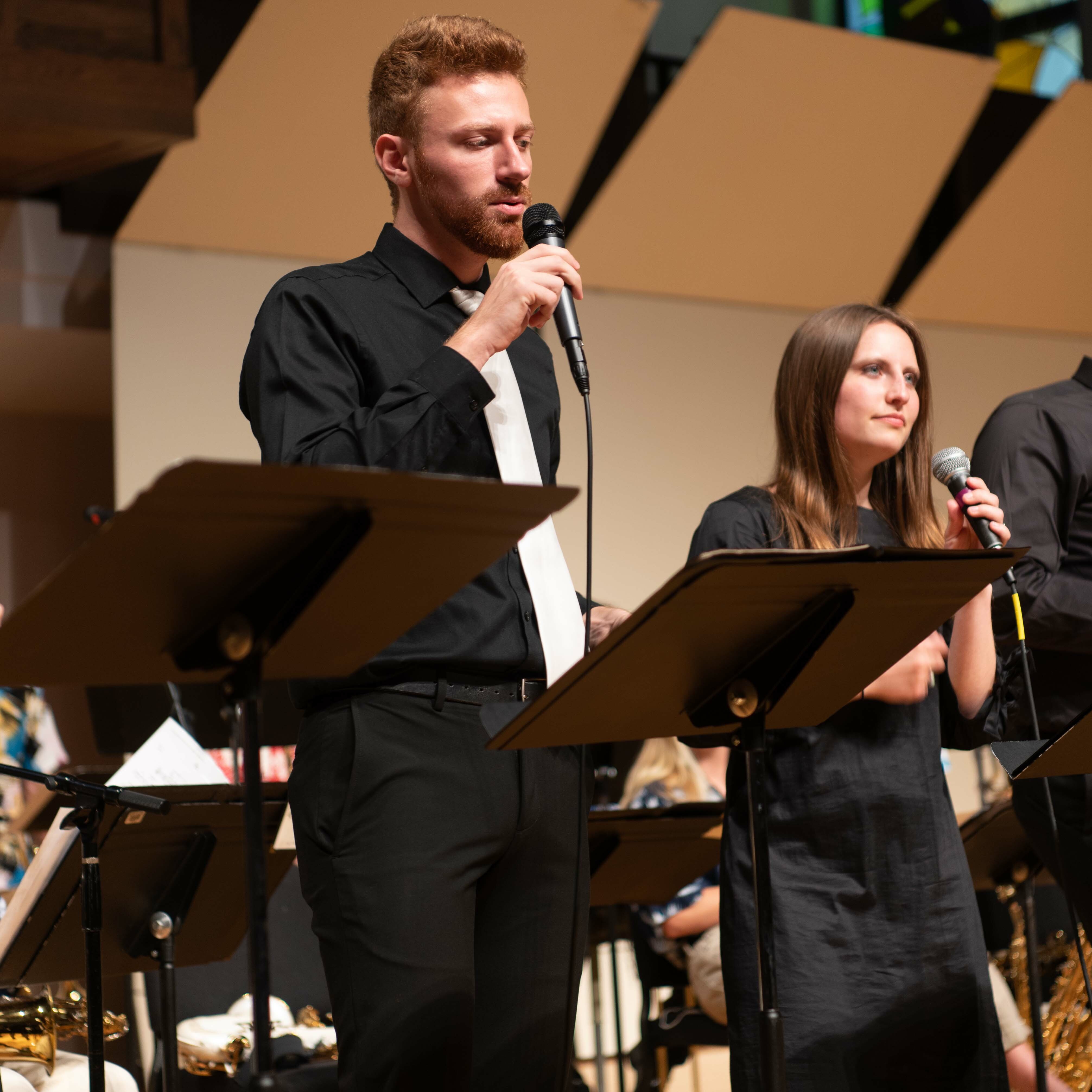 A picture of two Dordt singers during a performance