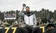 A coach takes off his hat to pray with the football team