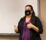 A professor teaches class with a mask on