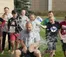 A picture of a teacher getting water poured over him by students