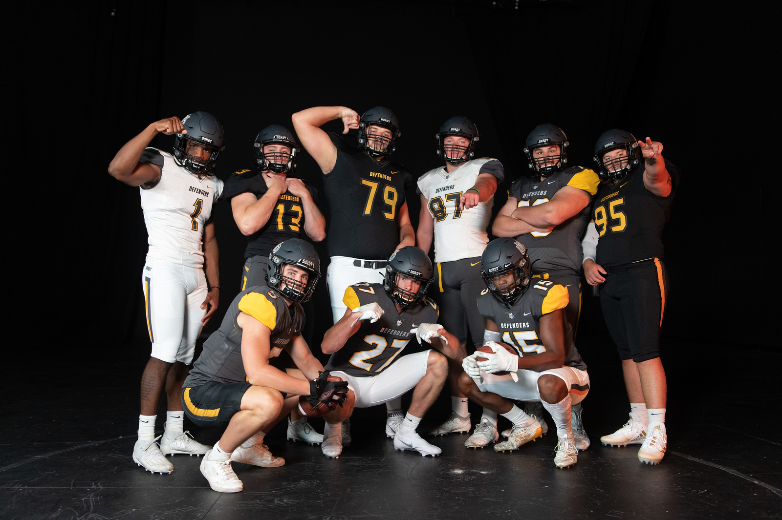 Dordt football players flexing and posing for a group picture