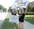 Two excited female students hold week of welcome signs