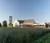 Campus Center building and clocktower in early morning with tallgrasses in the foreground