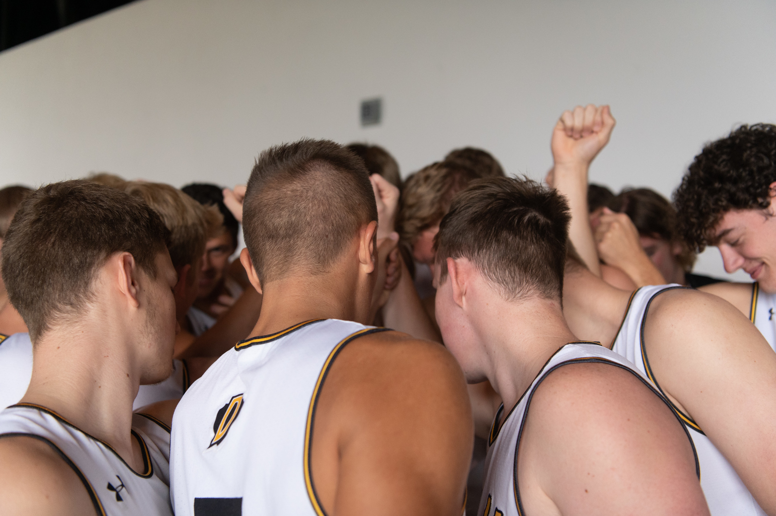 Dordt's men's basketball team during a huddle