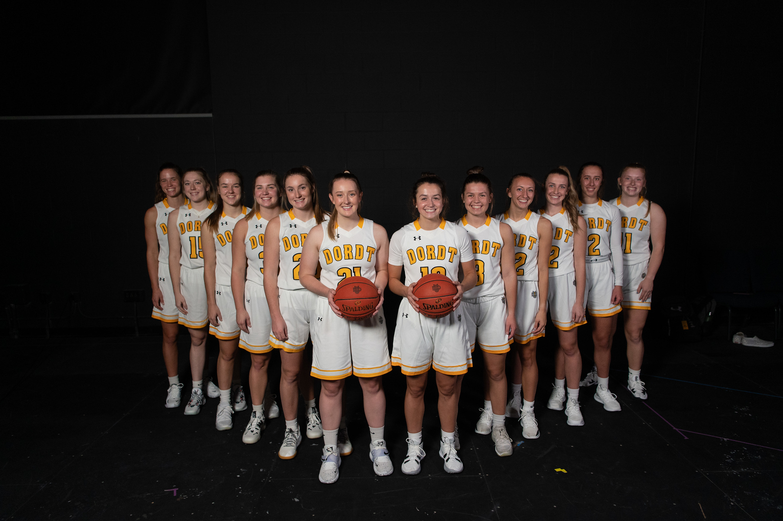 Dordt's women's basketball team stand in a V formation