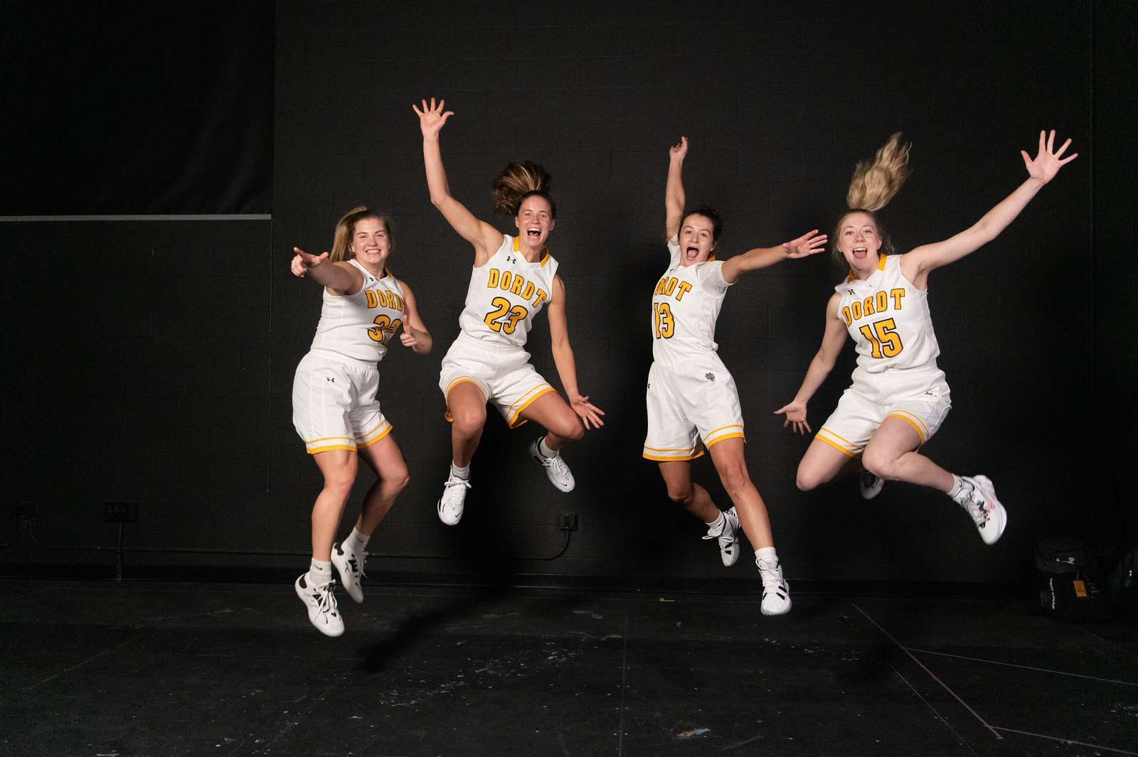 A group of basketball players jump for joy