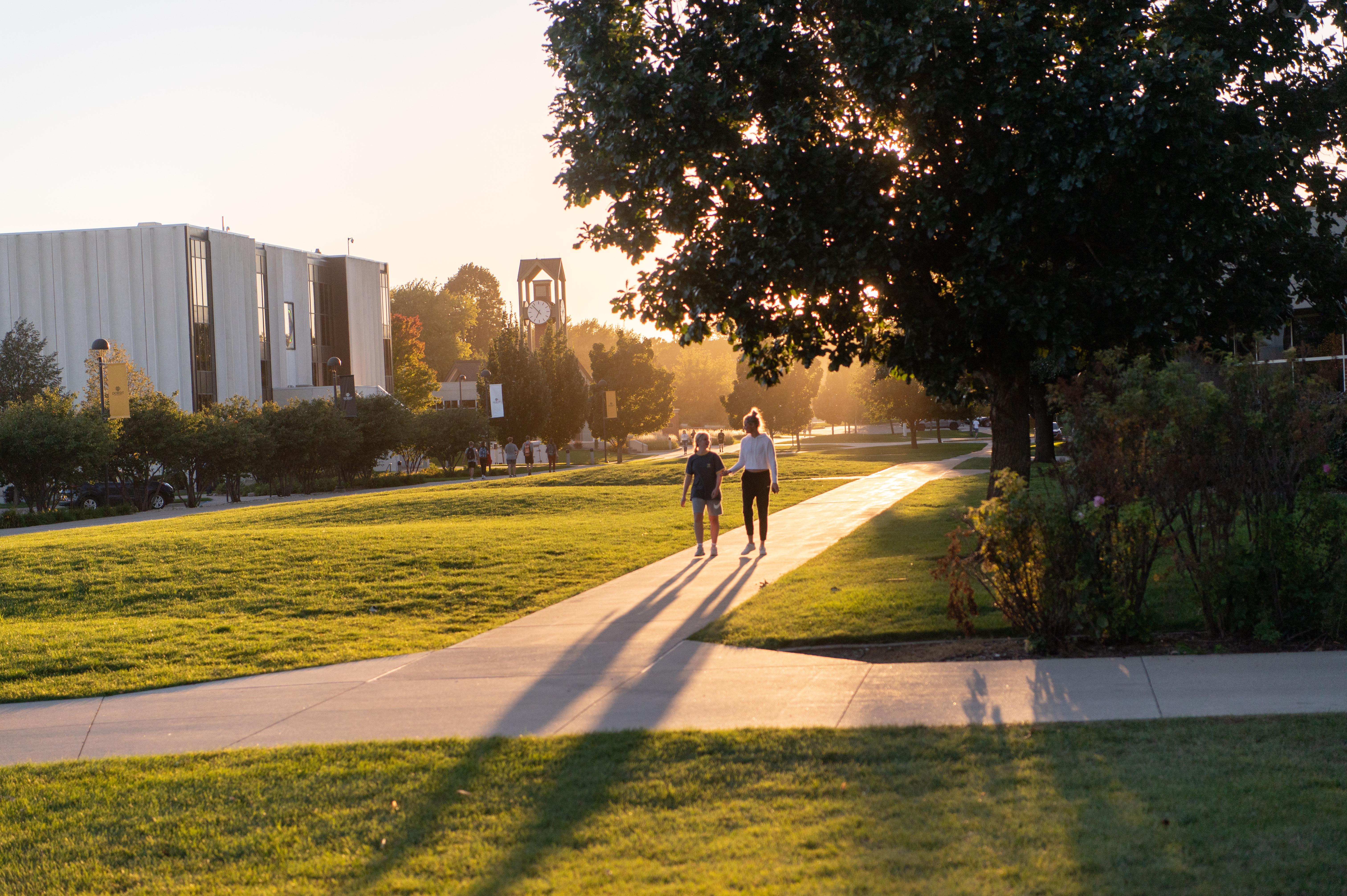 Two students walk down campus