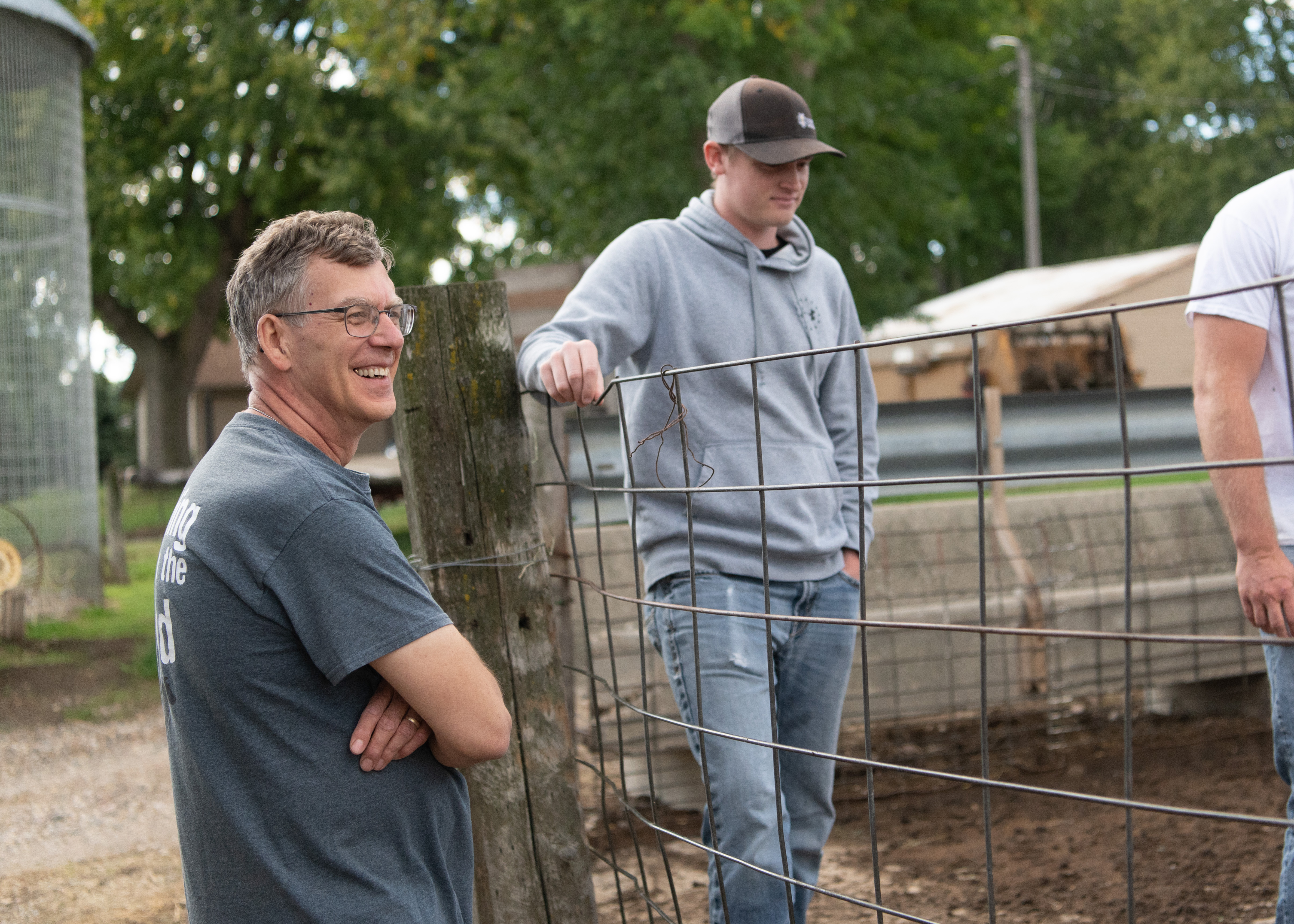 Dr. Olthoff and a student stand beside a sheep pen