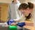 a female student sorts small plastic sample containers