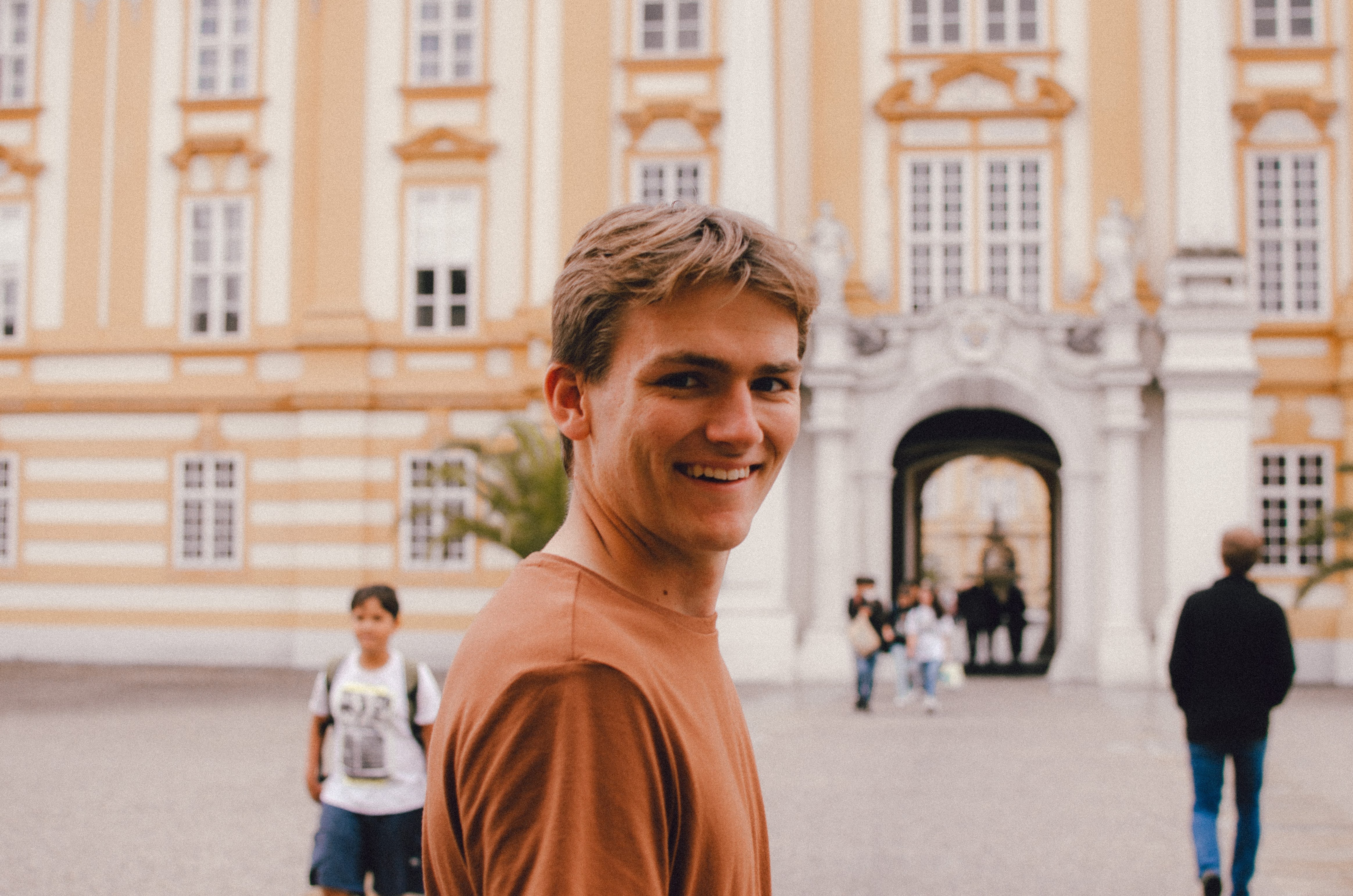 Dordt student smiles at the camera while in a foreign country town