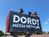 Dordt Media Network students stand by their cameras on a scissor lift at a football game