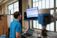 A student looks up at a monitor at his work station in the automation and manufacturing lab