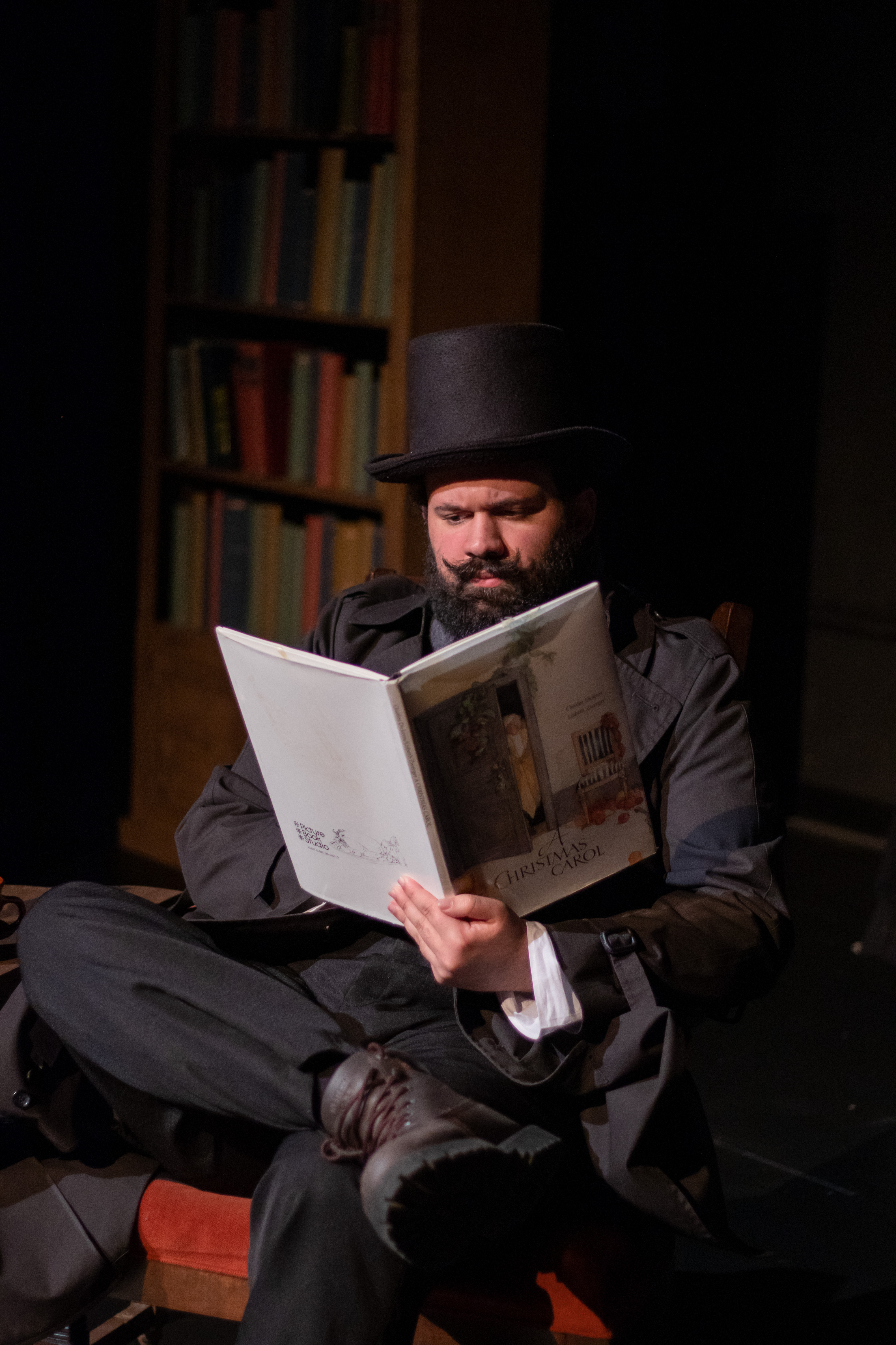 Actor with top hat reads A Christmas Carol