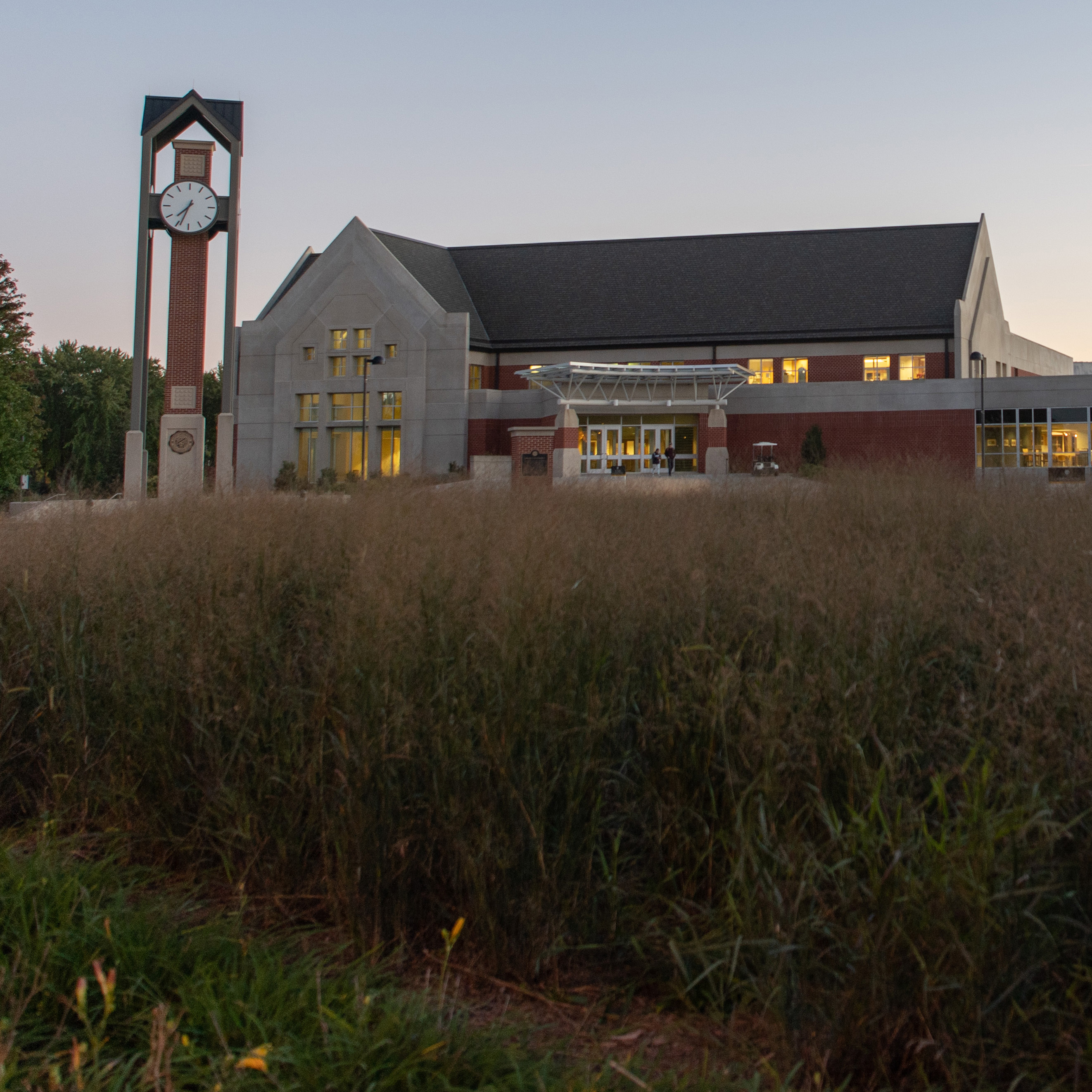 A picture of Dordt's Campus Center behind some prairie grass