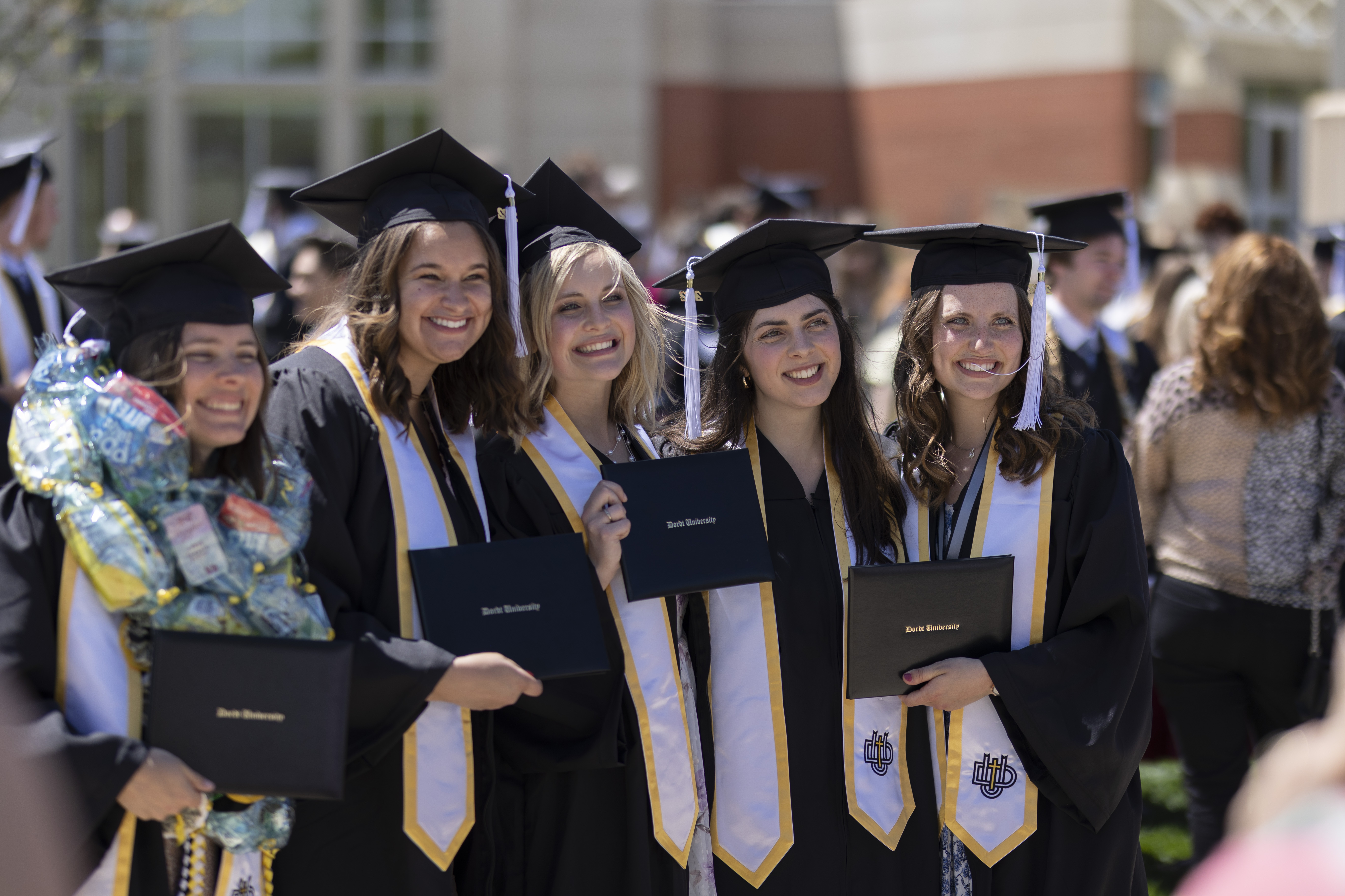 A picture of female students posing for a picture after graduation