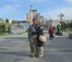 A couple takes a picture in a city