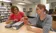 Two ladies sift through old tapes in the library