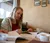 A student at a coffee shop looks down at a paper