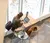 a female student sits working on her computer in a lobby