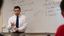 Male professor stands in front of class