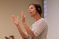 Female professor claps with her hands