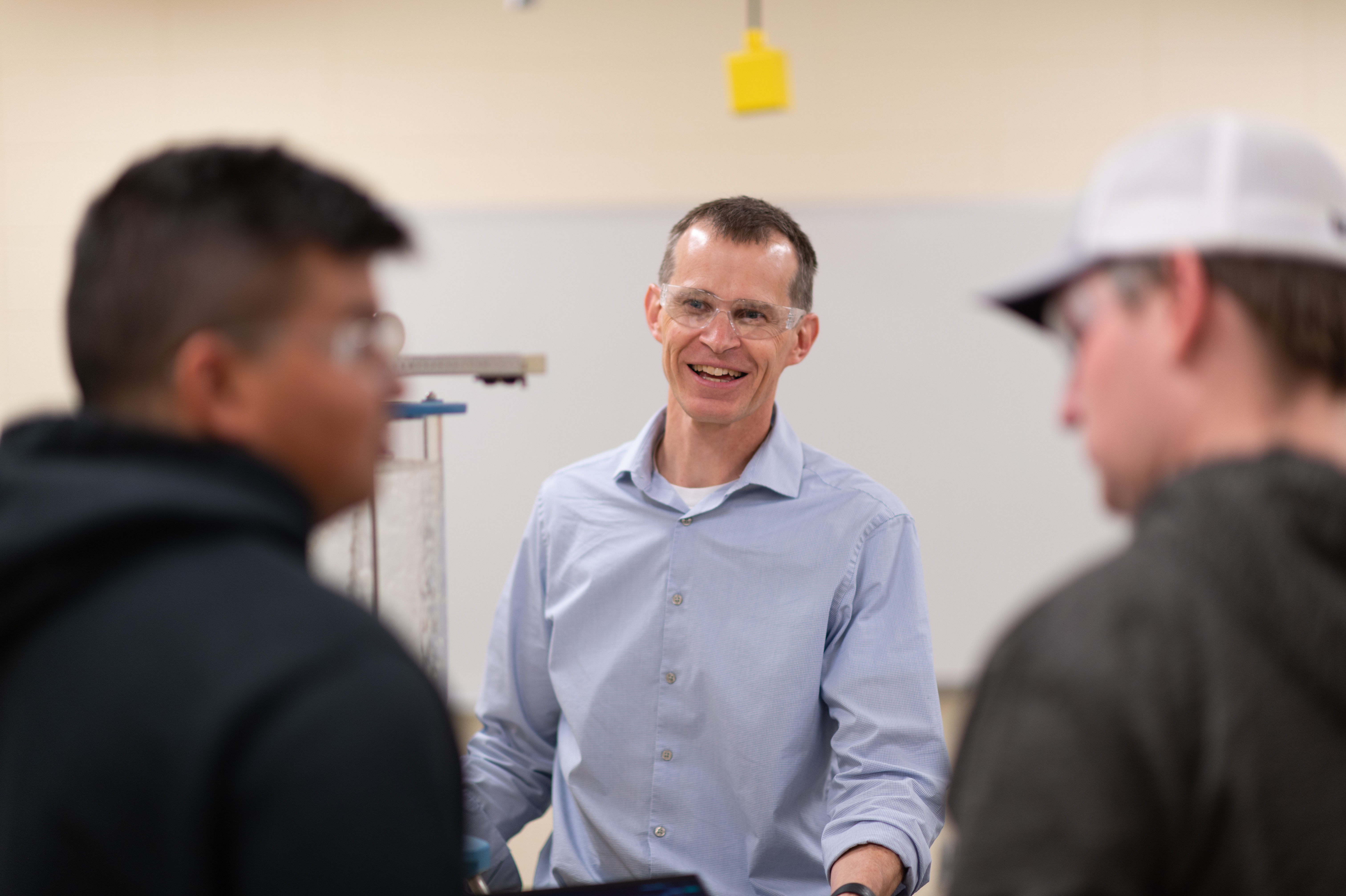 Professor chatting with students