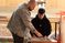 Male professor helping student draw