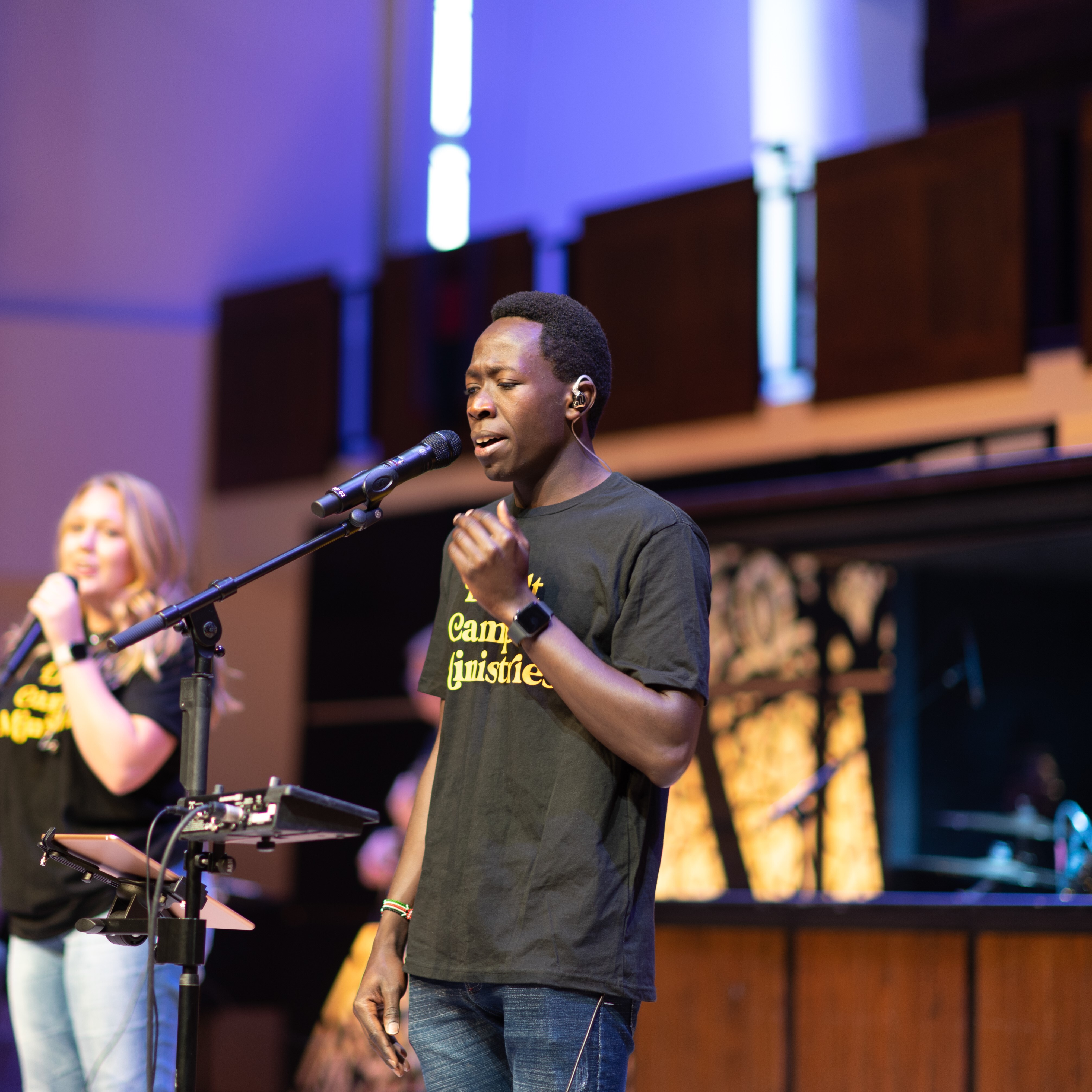 Male student singing on stage