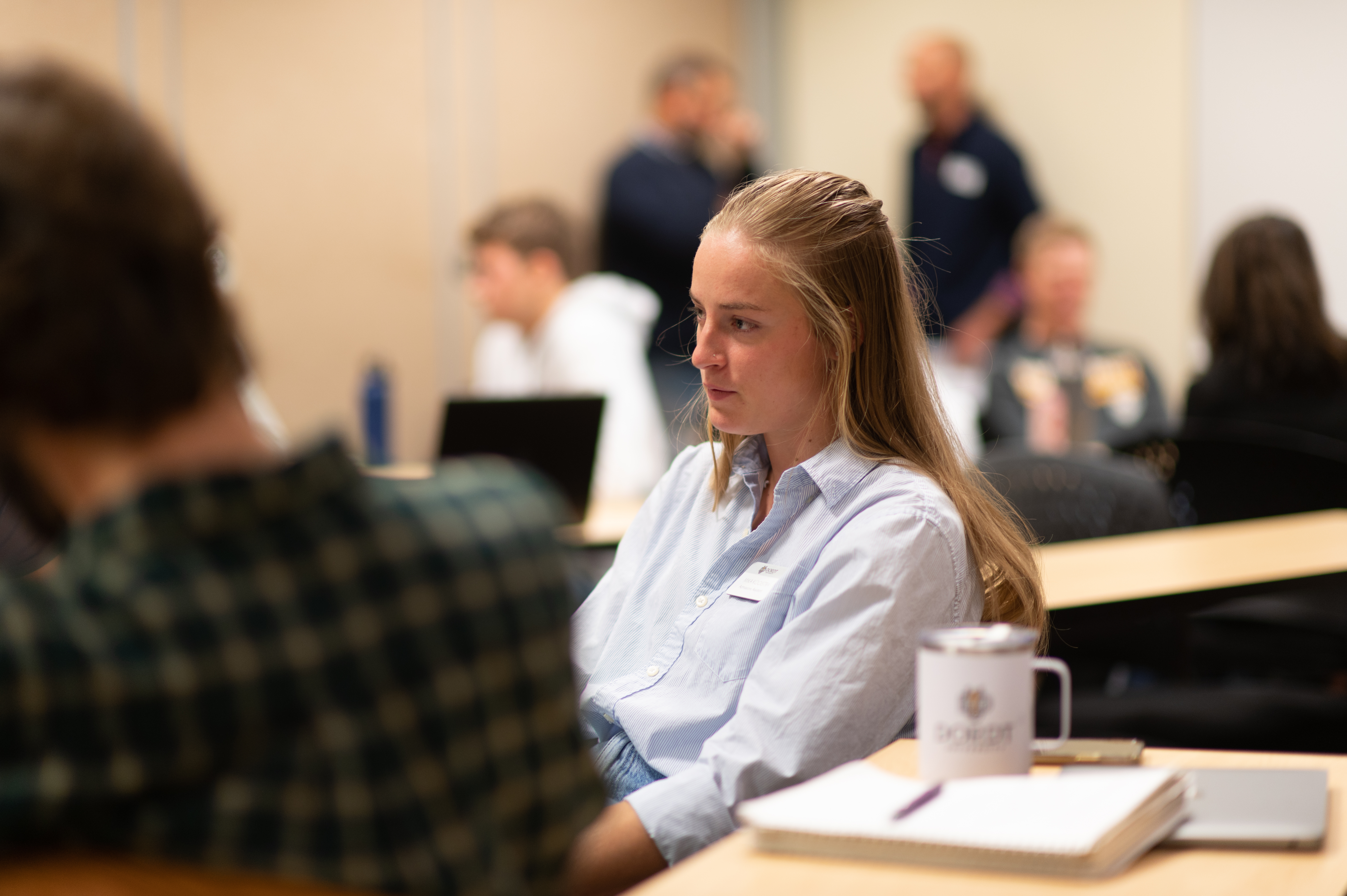 Female student listens to her classmates