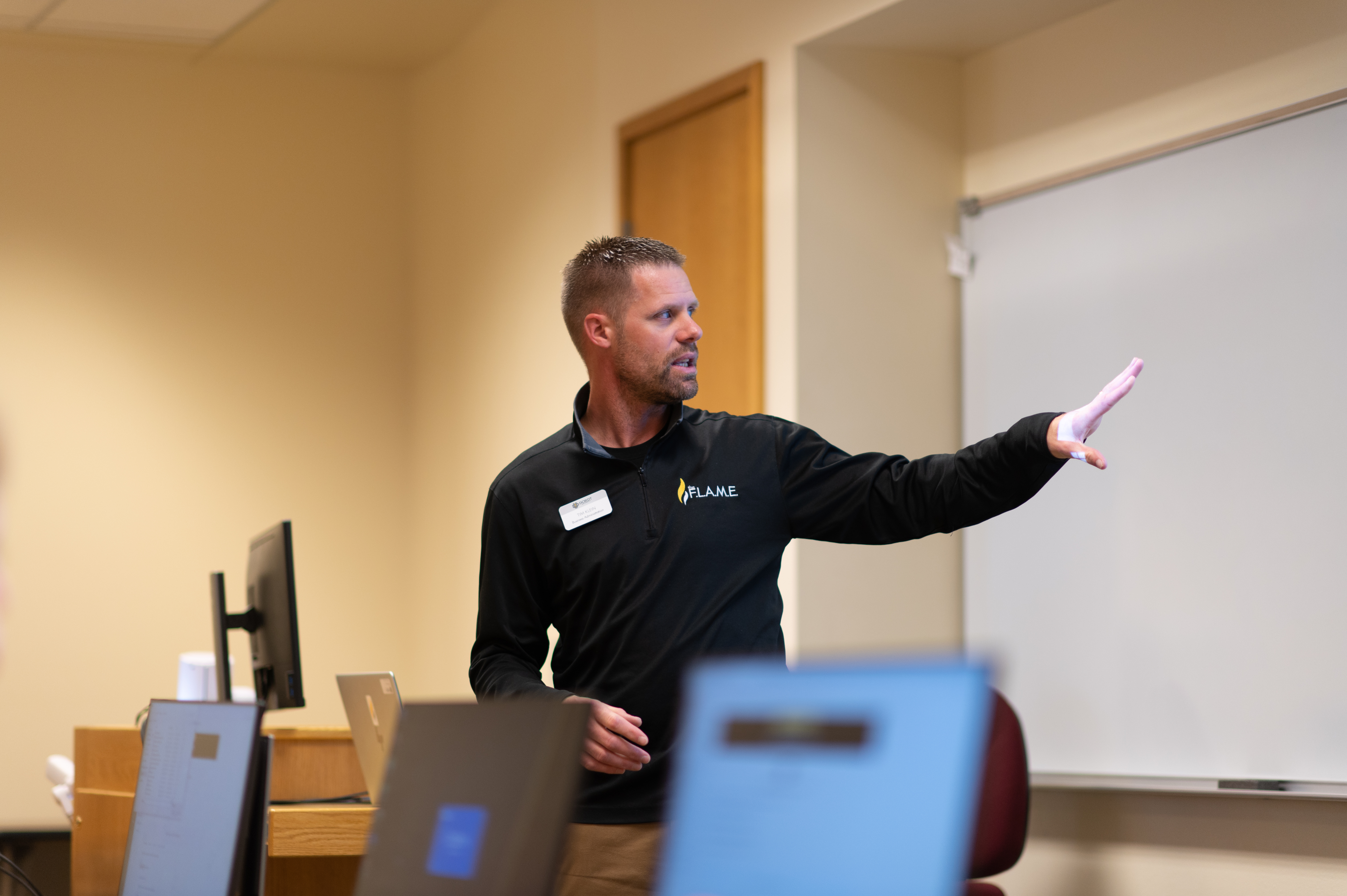 Male professor teaches to his class