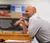Male professor leaning on a podium