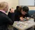 Students looking closely at IDs