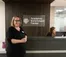 Director stands in front of Academic Enrichment Center front desk.