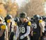 Football player walking next to the football field