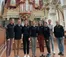 Students and faculty stand in front of famous organ