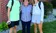 A grandmother stands with two grandchildren on the first day of class.