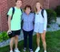 A grandmother stands with two grandchildren on the first day of class.