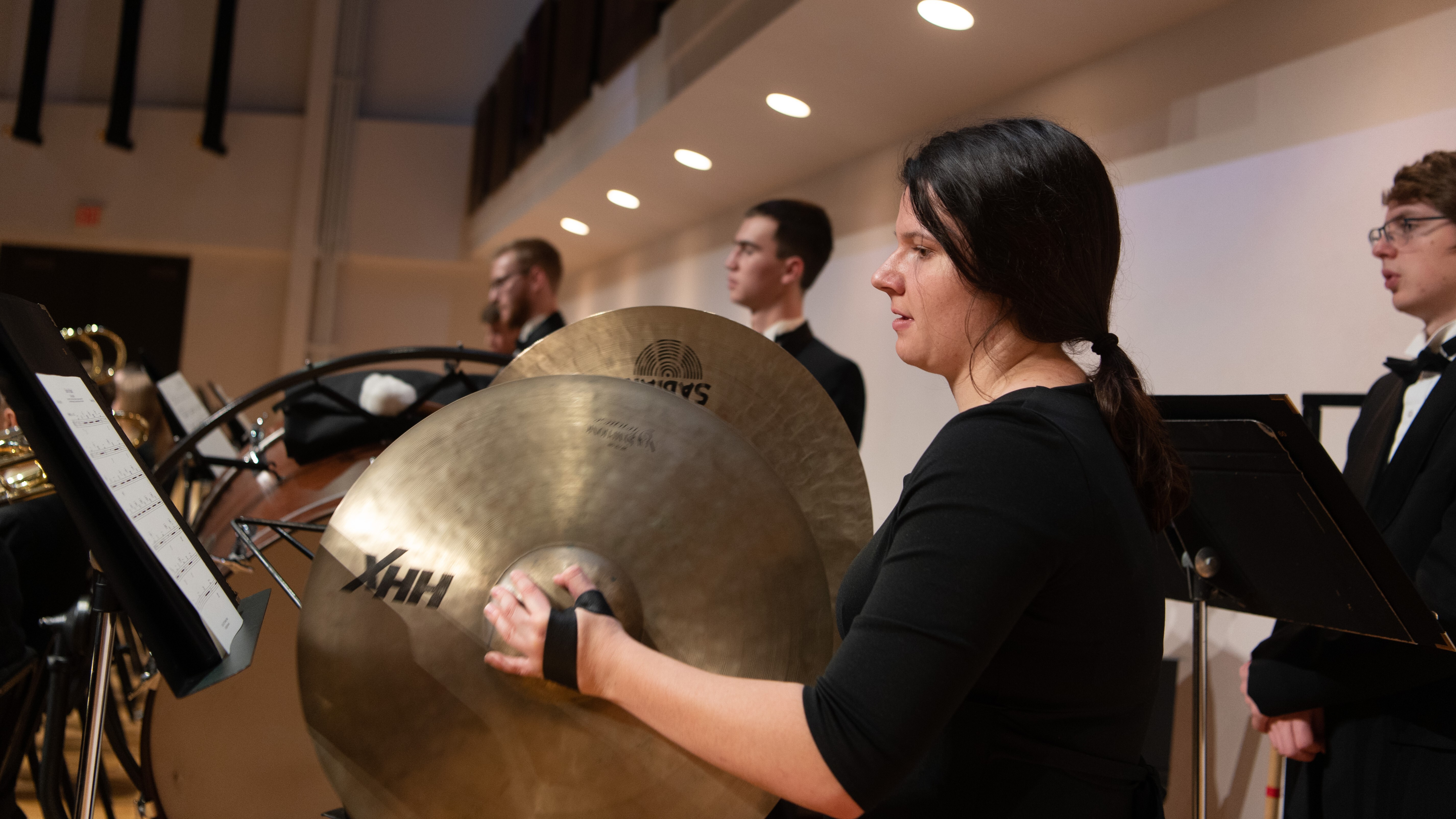 Female student plays cymbals